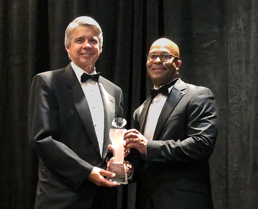 Eric Evans, left, with Brennon Marcano, right, CEO of the National GEM Consortium, accepts the leadership award at this year’s GEM Conference in Los Angeles. 