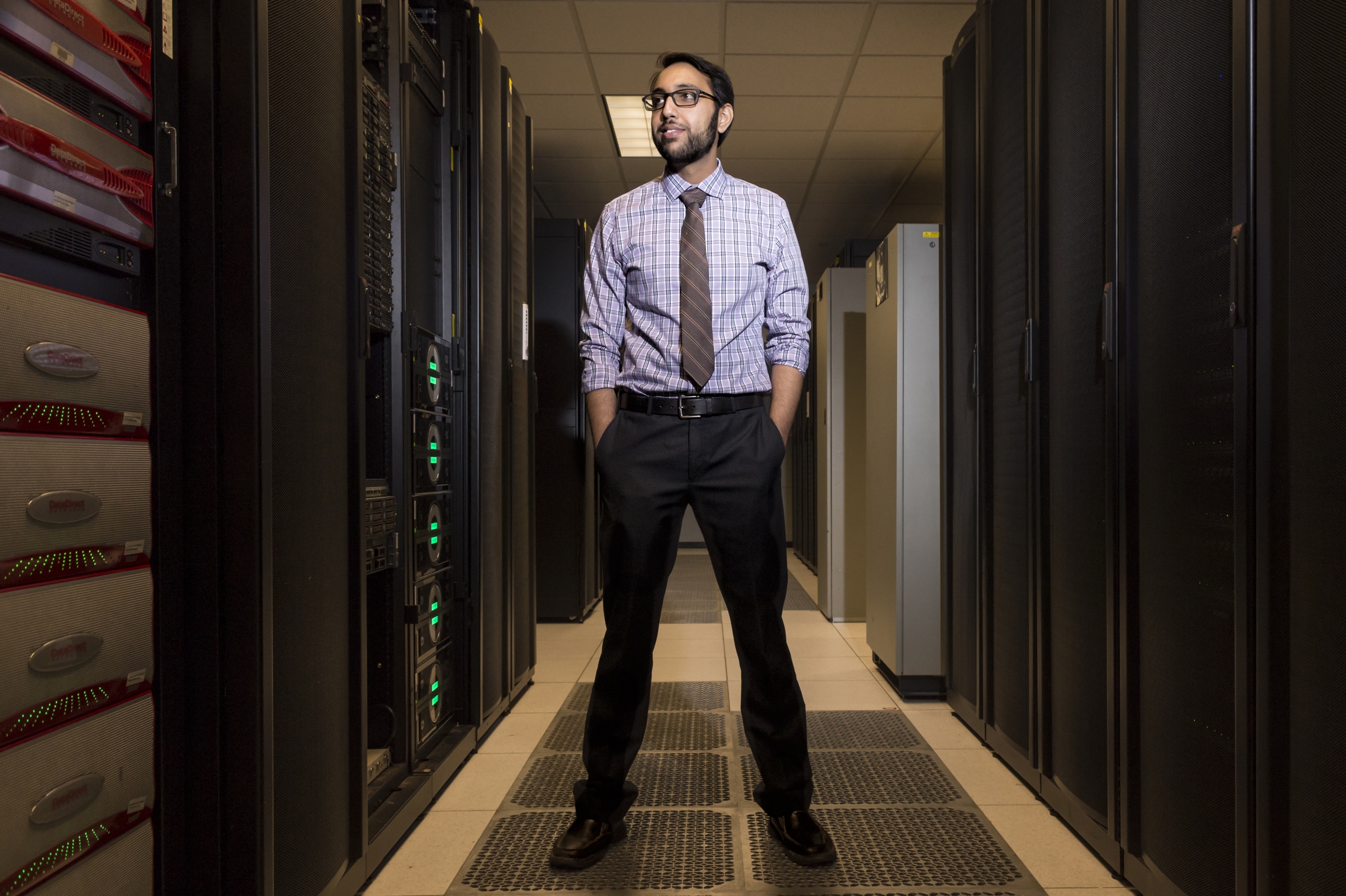 Vijay Gadepally stands in the supercomputing center