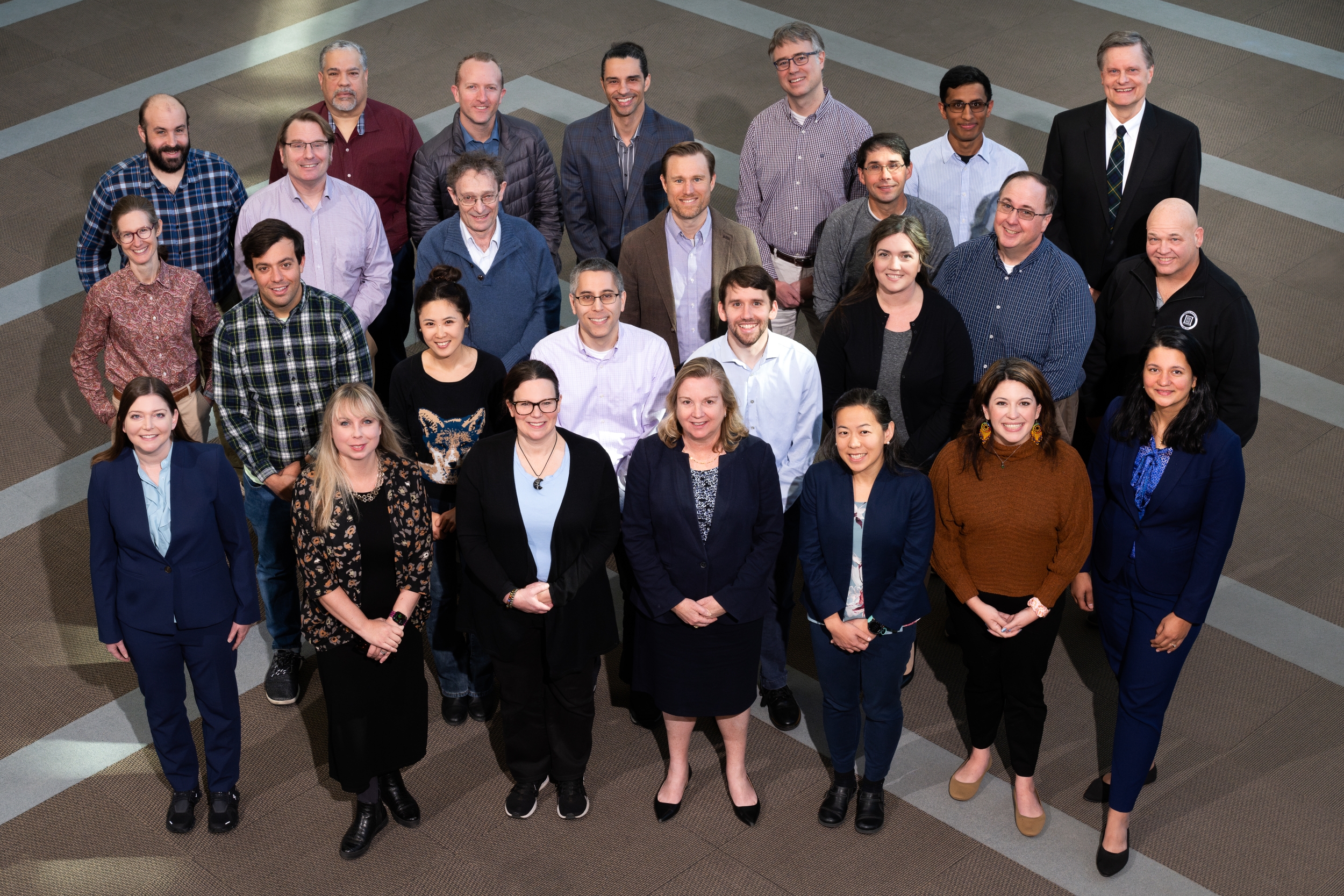 A group photo in the Laboratory's lobby showing RAAINS committee members. 