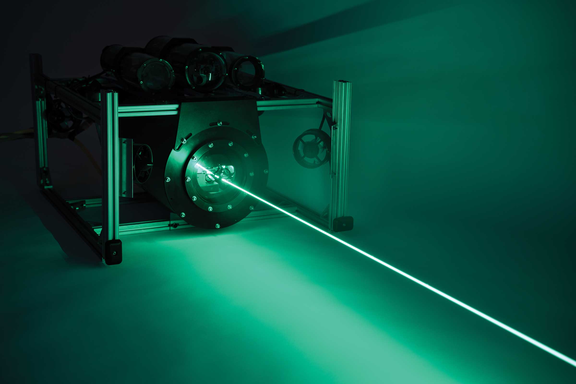 Photo of low-power laser beam that enables high-speed, low-observable links between undersea vehicles and through the air/sea interface.