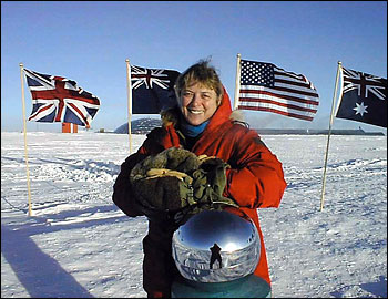 Dr. Jerri Nielsen stands at the ceremonial South Pole marker.