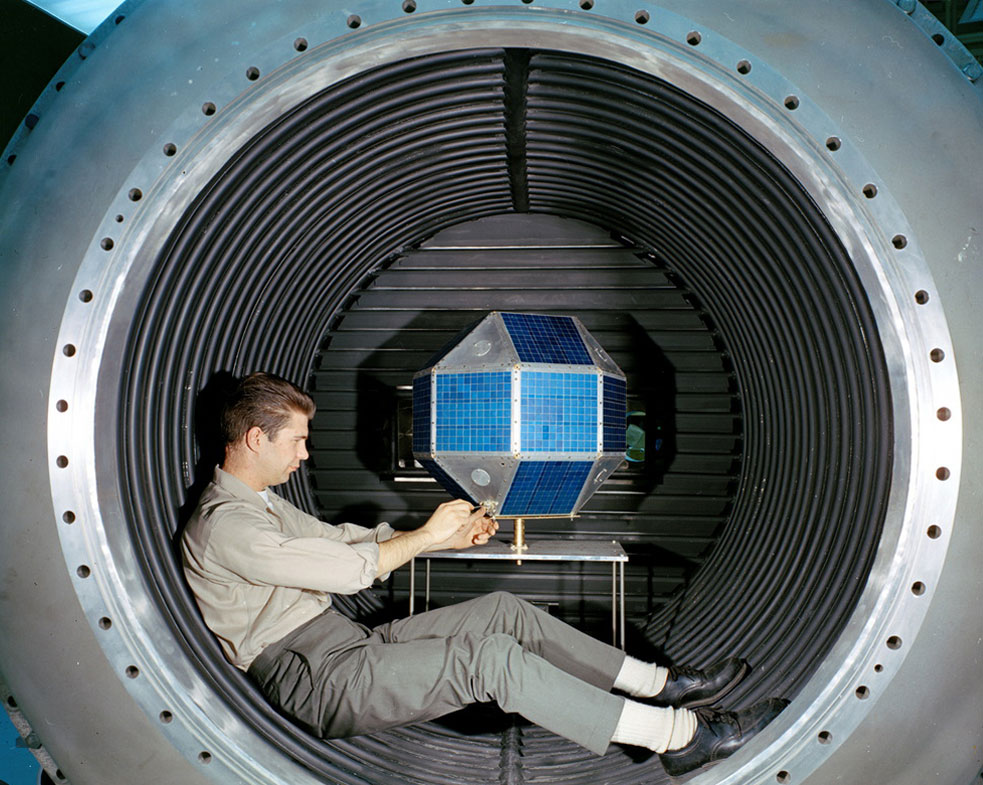 A researcher works on LES-3 inside a tank.