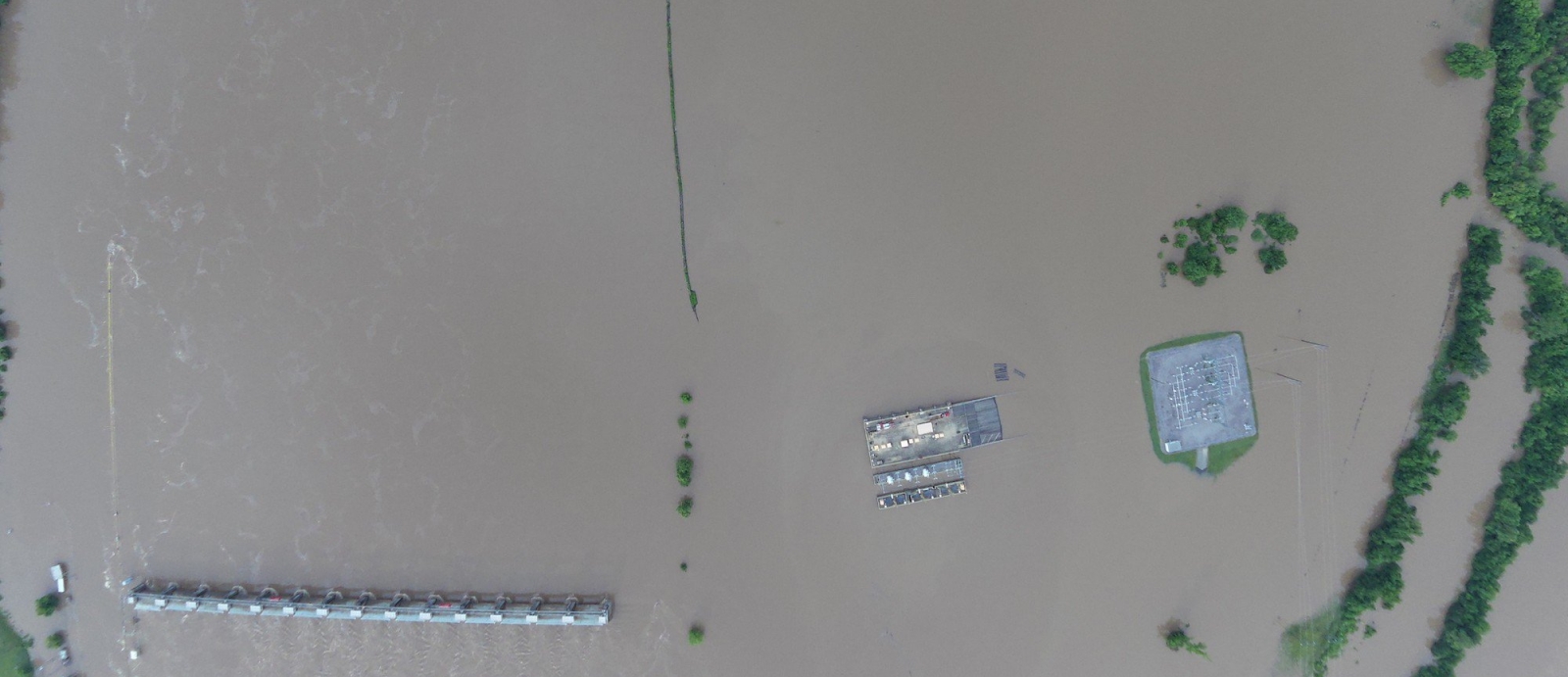 aerial photo of a flooded area with building roofs visible. 