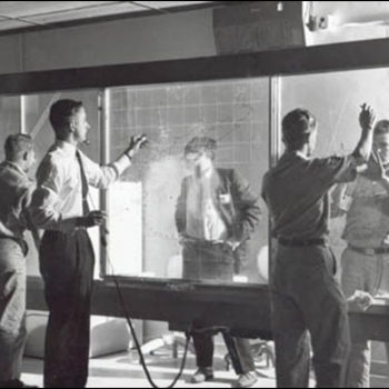 Researchers at MIT's Barta building perform strobe tracking on a manual plotting board for the Experimental SAGE Sector (ESS). Picture used with the permission of the MITRE Corporation (copyright © The MITRE Corporation. All rights reserved).