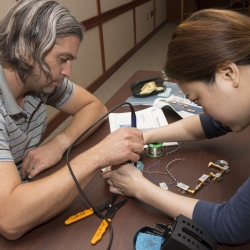 Brunner (left) assembles a radar component with help from one of the LLRISE instructors.