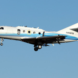 an airplane flying against a blue sky background